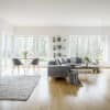 Open living room with white oak hardwood floor by Riva Spain by Floors