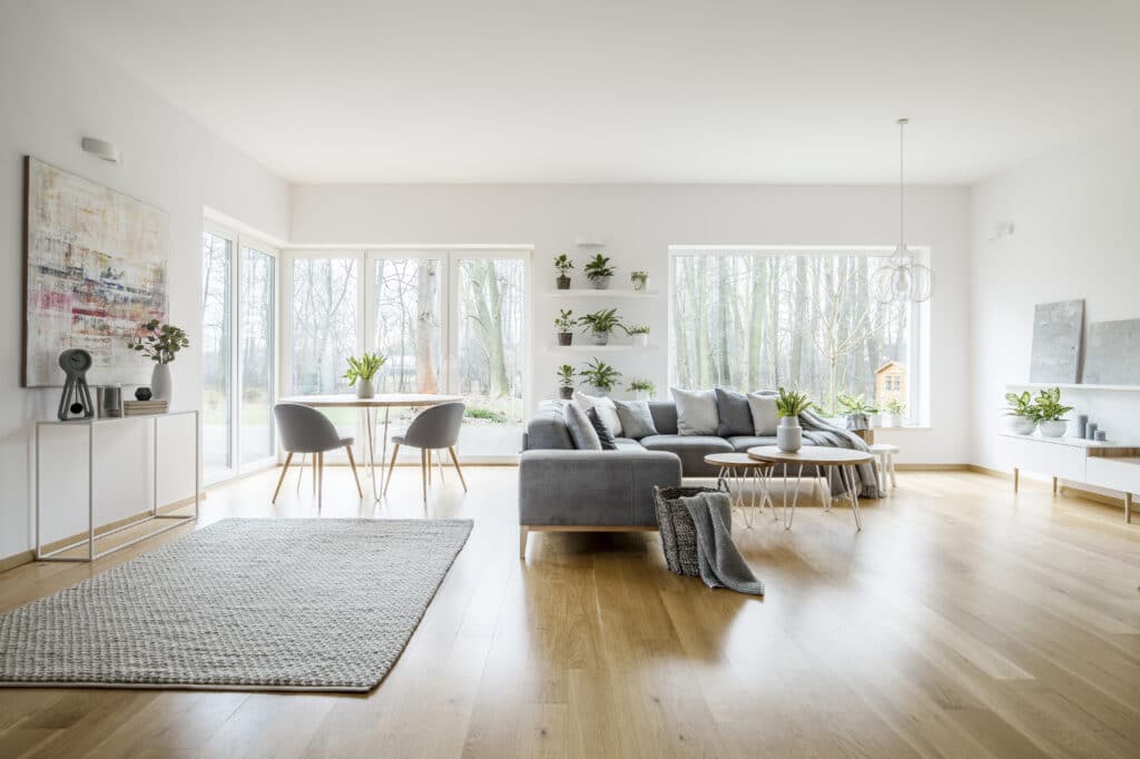 Open living room with white oak hardwood floor by Riva Spain by Floors